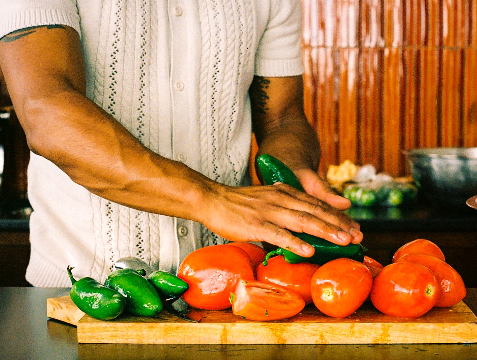 Oliver hand-picking fresh tomatoes and jalapeños
